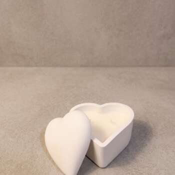 Vela artesanal Cofre Corazón en recipiente blanco con forma de corazón y tapa.
